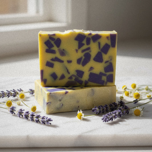 Lemon Lavender goat milk soap on marble with lavender sprigs and chamomile