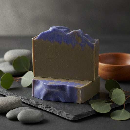 Vanilla Fig goat milk soap on slate with river stones and eucalyptus
