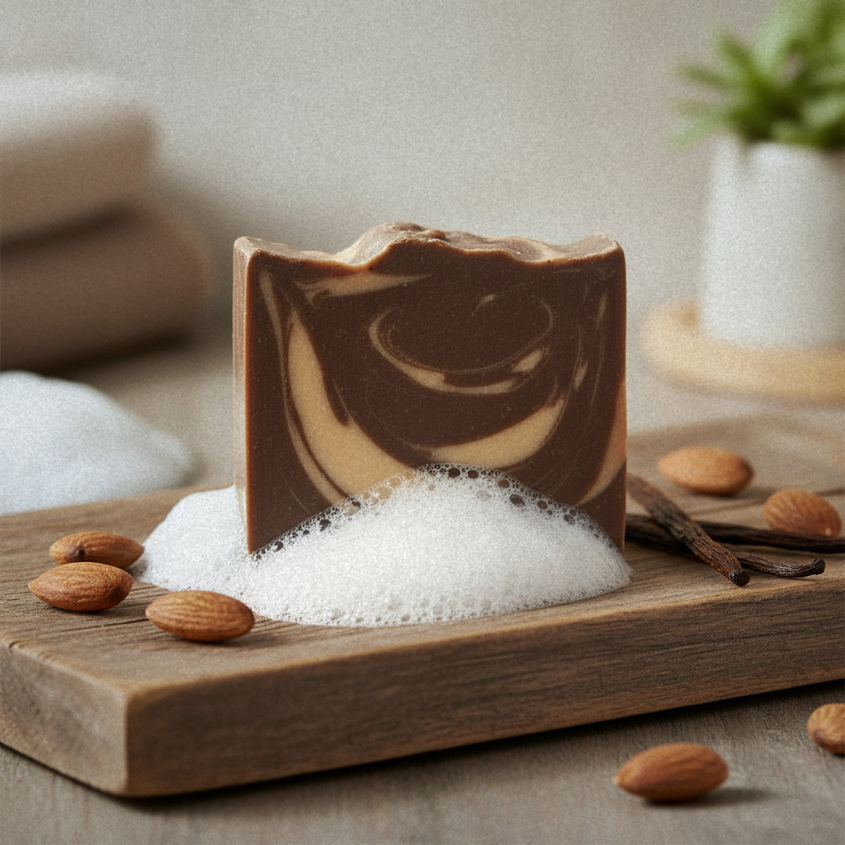 Almond Biscotti goat milk soap on a wooden board with lather and almonds