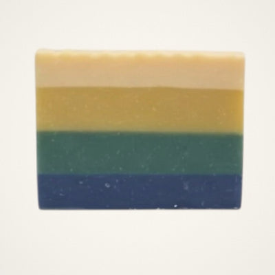 Green Clover & Aloe goat milk soap bar with cream, gold, green and navy stripes on a white background