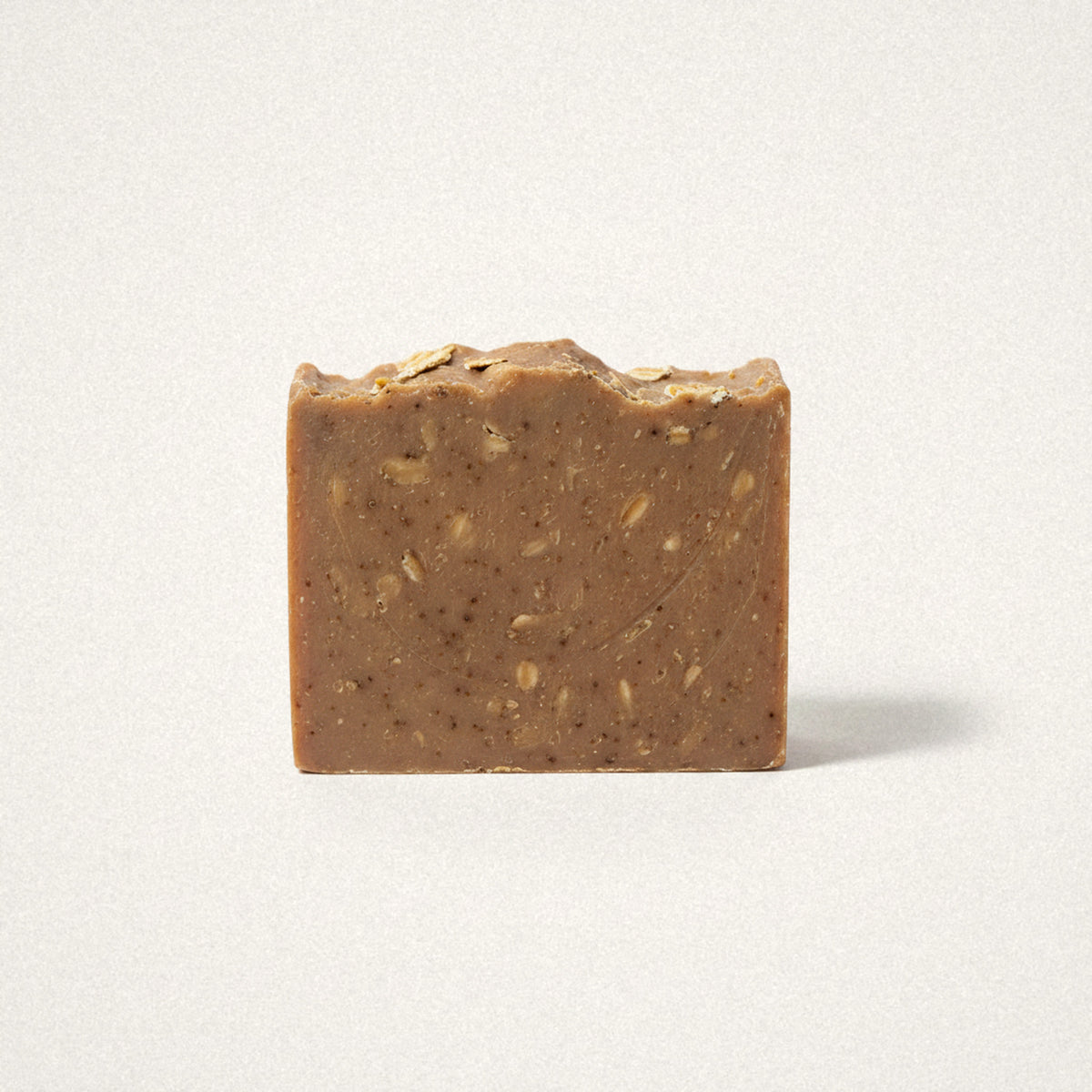 Purely Oats goat milk soap bar, oat brown with visible oat flecks, on a white background