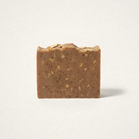 Purely Oats goat milk soap bar, oat brown with visible oat flecks, on a white background