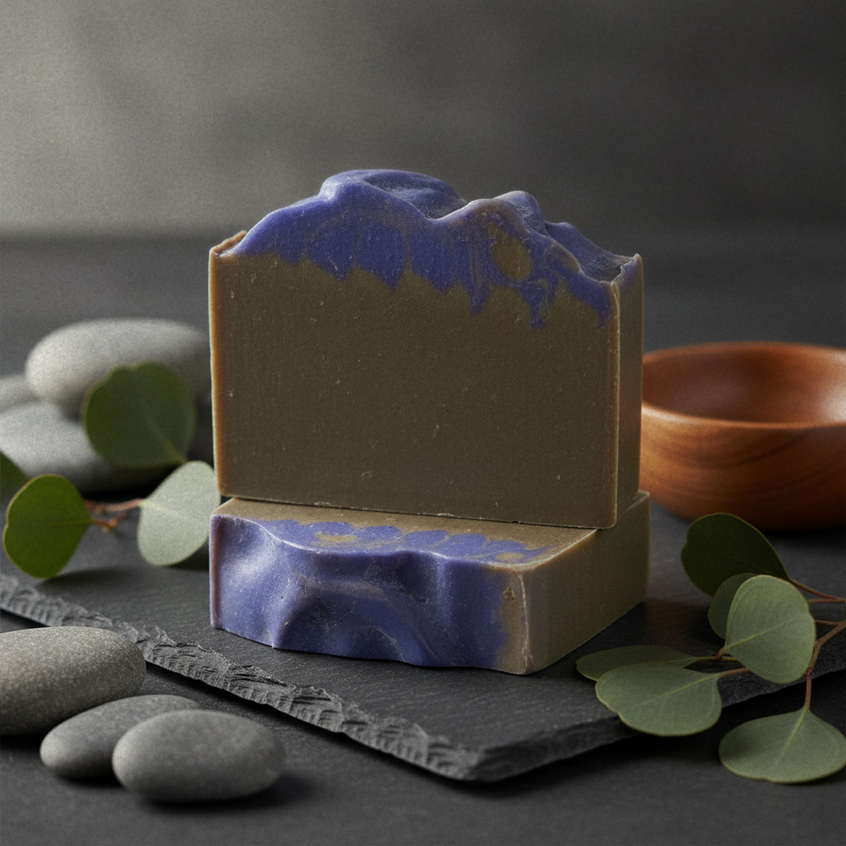 Vanilla Fig goat milk soap on slate with river stones and eucalyptus